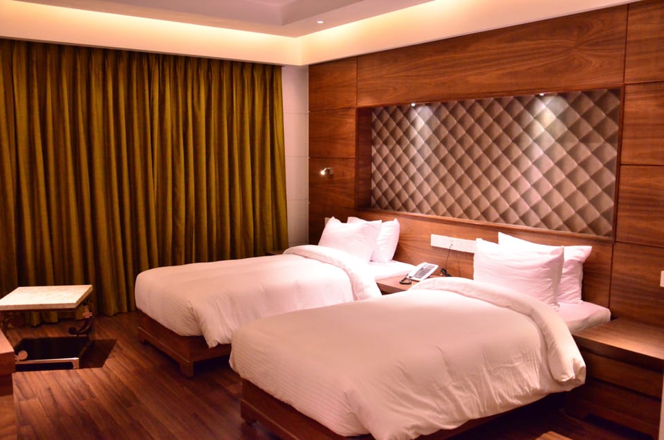 Deluxe Room, City View | In-room safe, desk, laptop workspace, iron/ironing board