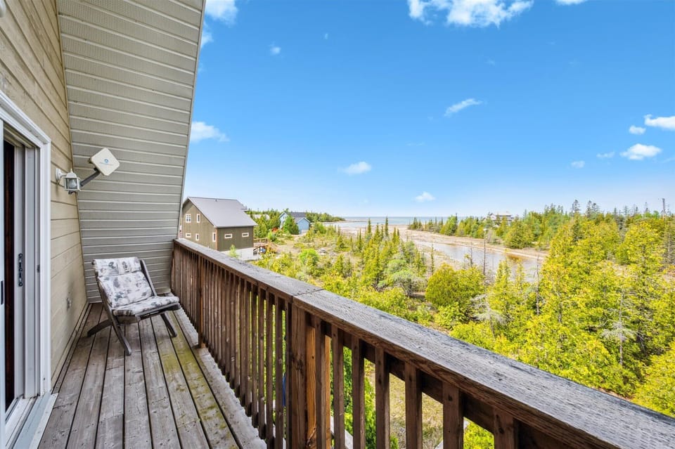 Step out from the primary bedroom to your private balcony and take in sweeping views of Dorcas Bay and Lake Huron.