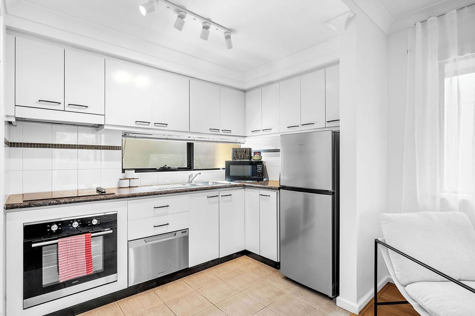 Fully equipped modern kitchen with oven, dishwasher, and ample storage. Ready for all your culinary needs.