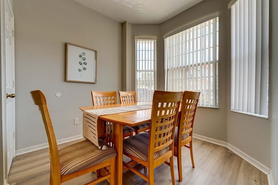 Dining area with natural light and wooden furniture for family meals.