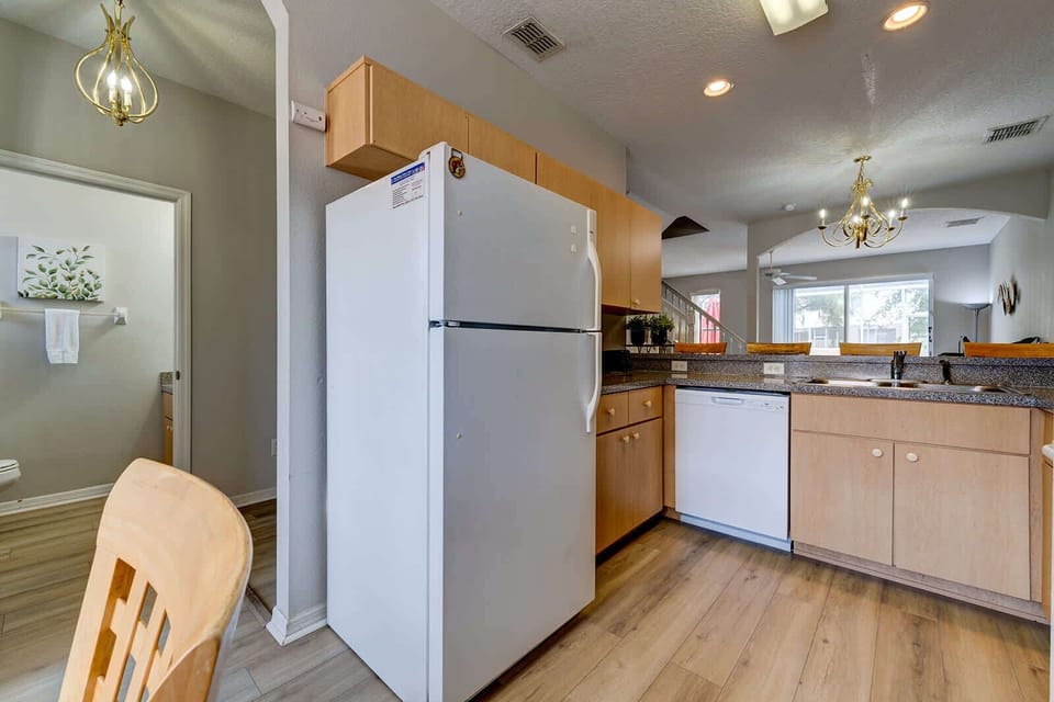Open kitchen with modern appliances and a view into the dining and living area.