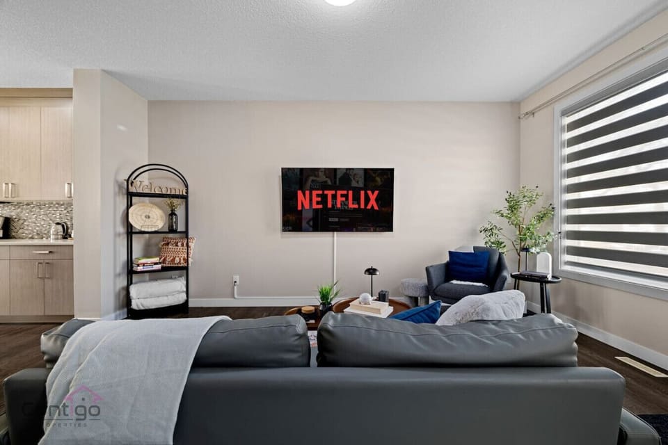 Unwind in style! Sink into the plush sofa and enjoy your favorite shows on the Smart TV. This cozy space also features convenient shelving and natural light, perfect for a relaxing stay.