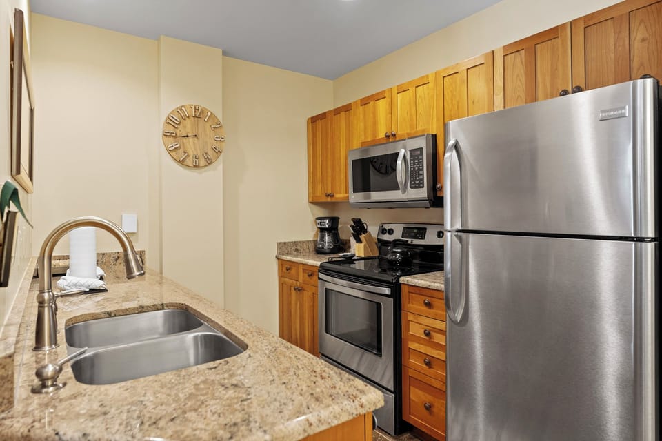 Your fully equipped kitchen features granite countertops, stainless steel appliances, and warm wood cabinets for effortless meal preparation.