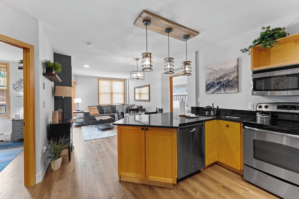 Step into your bright, modern kitchen where sleek granite counters and warm wood cabinets create the perfect space for cooking memorable meals.