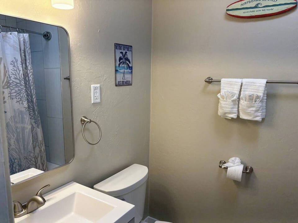 Full bathroom with shower/tub combo, hair dryer, shampoo, conditioner, body wash
