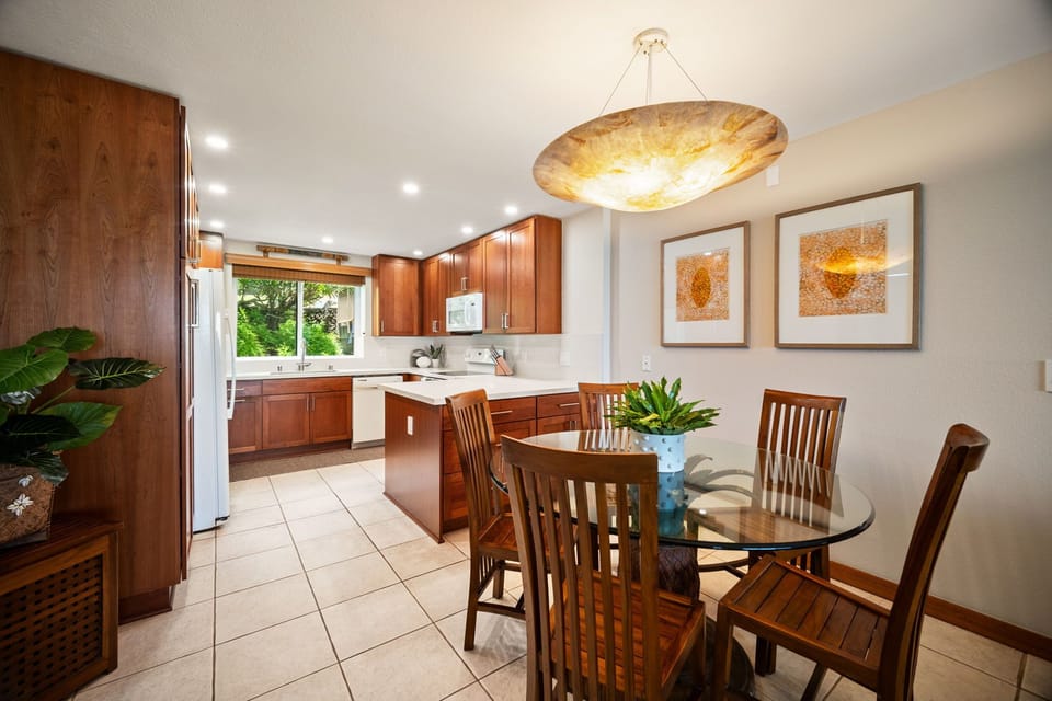 Gather around this welcoming dining space where warm wood tones and a stunning pendant light create the perfect setting for your island meals together.