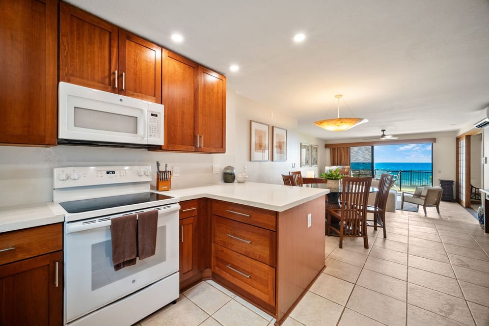 Step into your oceanfront retreat with a fully-equipped kitchen where you can prep meals while gazing at turquoise waters. The open layout flows seamlessly to your dining and living areas, all bathed in natural light.