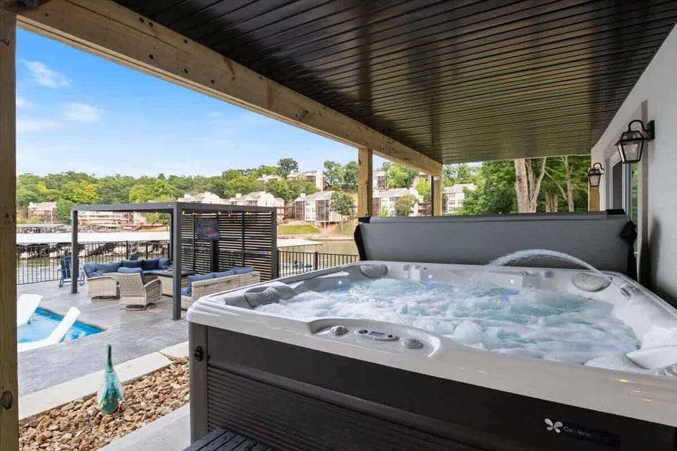 Private hot tub on the covered deck overlooking the lake for a relaxing getaway.