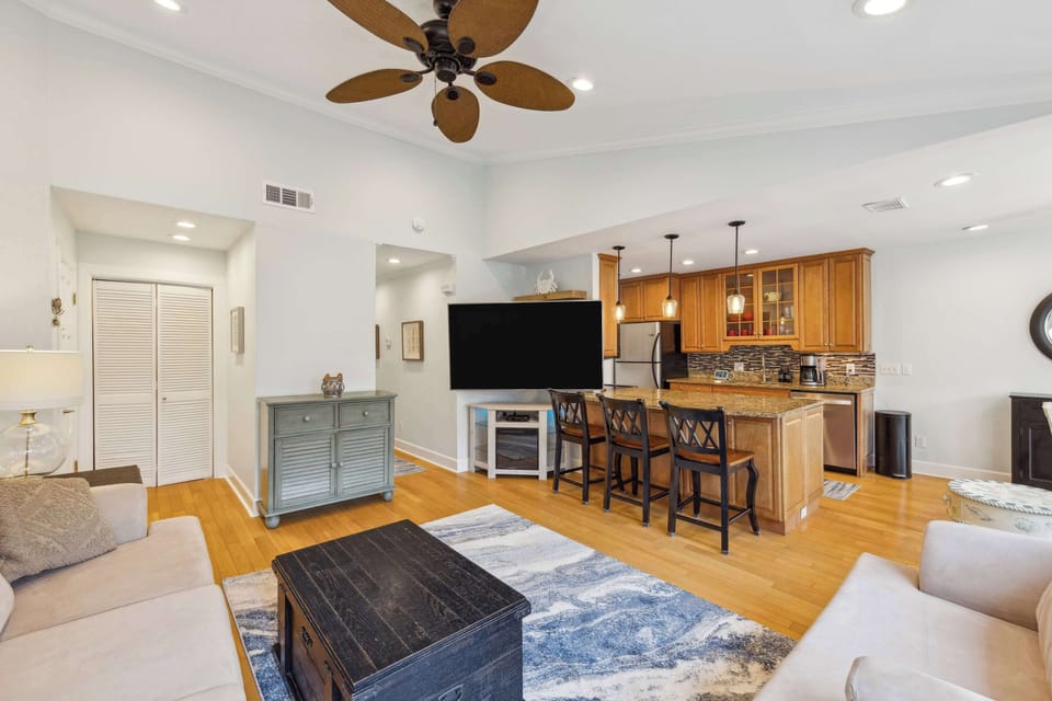 Living area with ample seating, TV, and balcony 