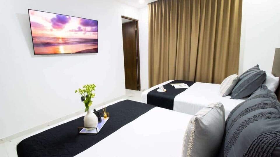 A wall-mounted TV for bedtime viewing