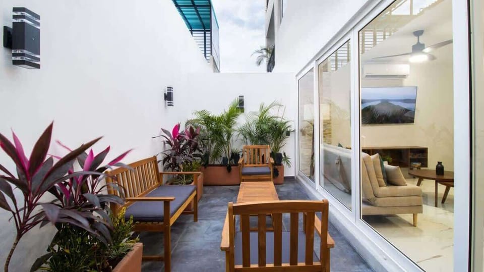 Private outdoor patio with lounge seating and a private hot tub