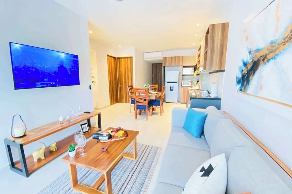 The sitting area features a comfy sofa and Smart TV