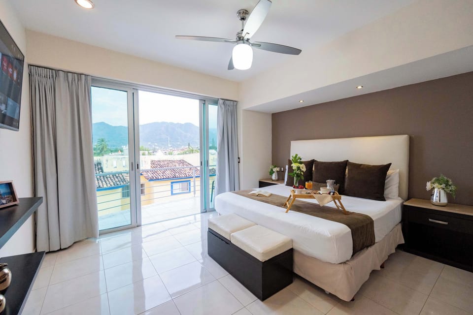 Main bedroom with king size bed, TV, ensuite bathroom, A/C and view