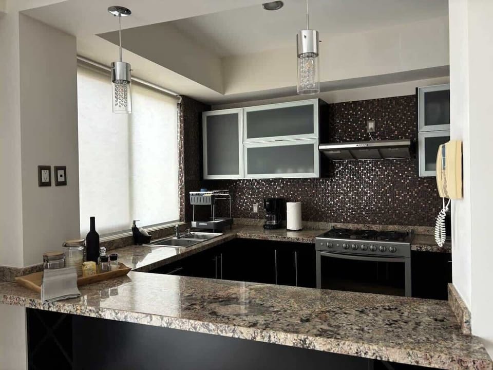 A spacious, fully-equipped kitchen with granite countertops & quality appliances!