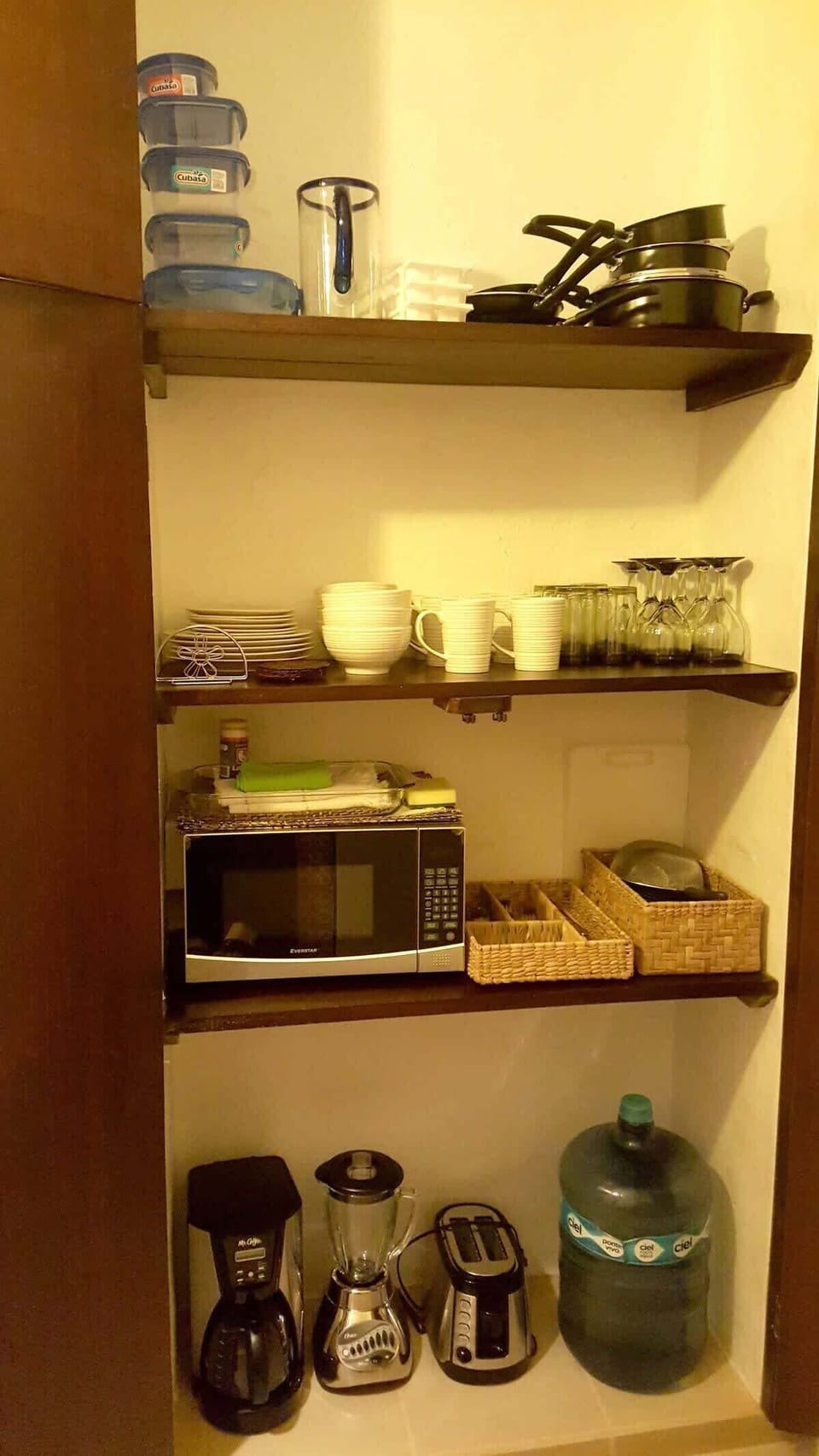 Inside the kitchen, there is a cabinet where you will find: Microwave, cofee maker, toaster, blender, pans and pots, and more...
