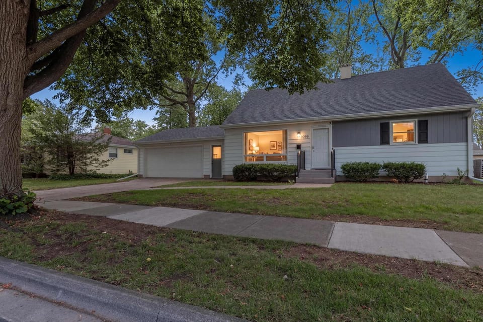Warm and inviting, the home glows beautifully at dusk, with soft lighting highlighting its charm and curb appeal. The peaceful evening setting creates a cozy, welcoming atmosphere—perfect for relaxing nights and memorable stays.