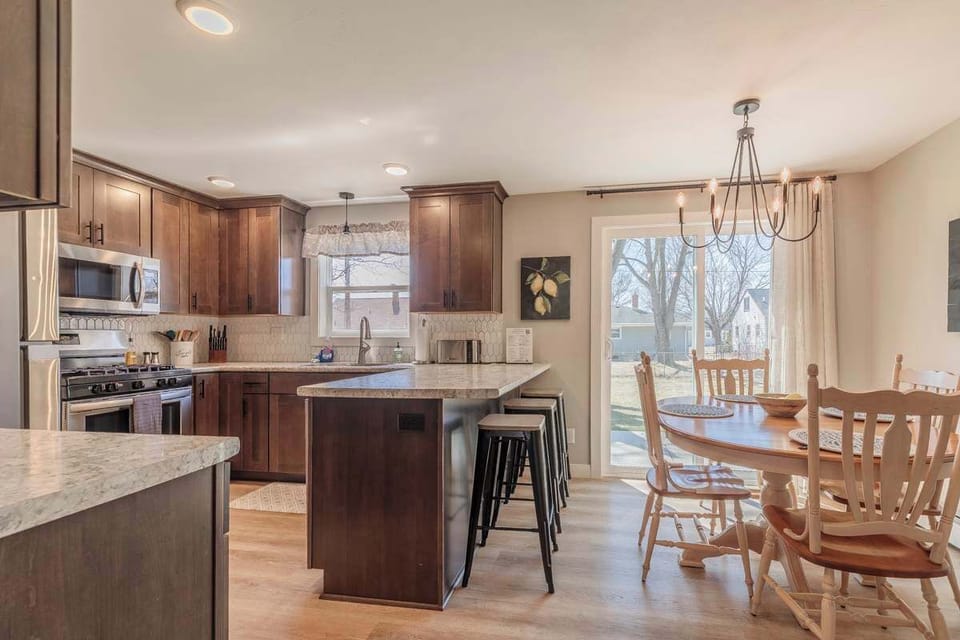 Bright kitchen and dining area with sliding doors that open to a private back patio. Enjoy meals indoors or step outside for fresh air and outdoor dining.
