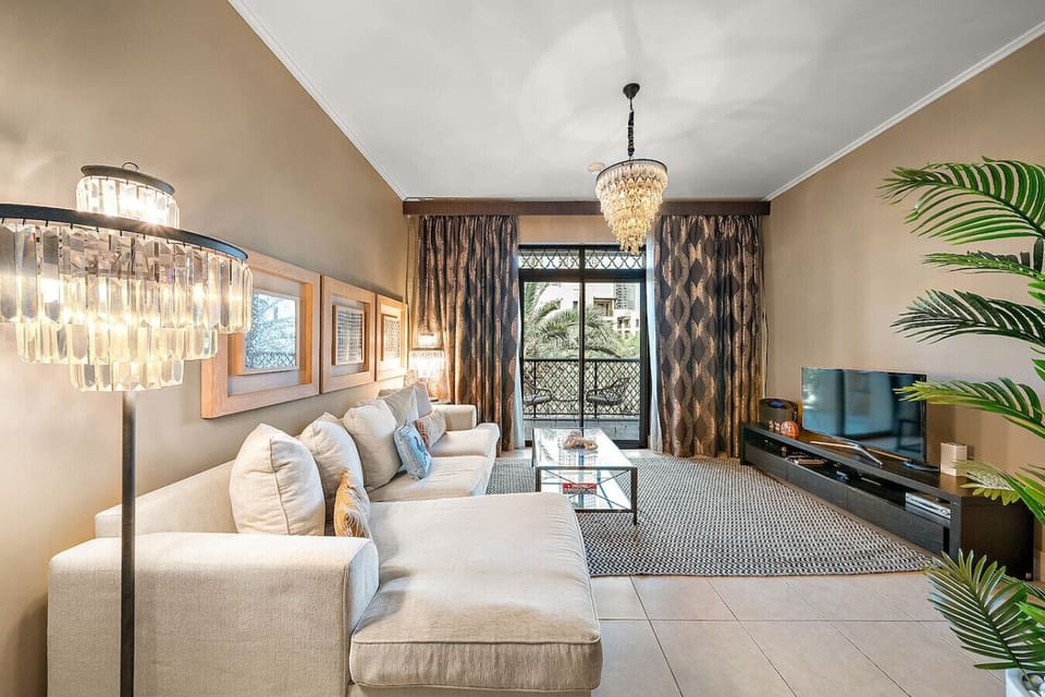 Living Room: Bright space with chic decor, natural light, and stunning views of palm trees!