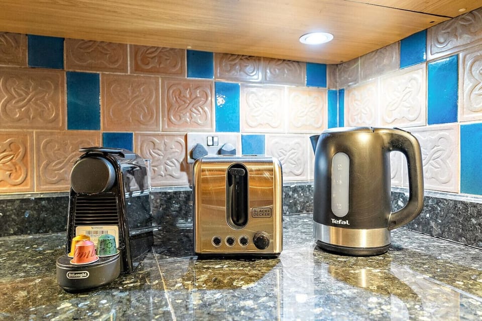 Kitchen Essentials: Brew your morning coffee with sleek appliances and vibrant tile accents!