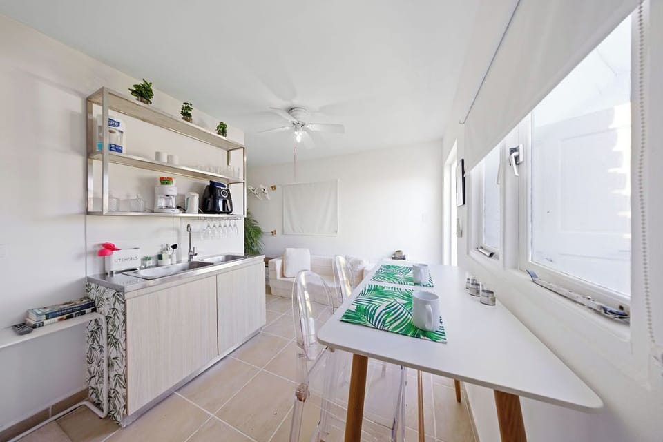 Prep light bites with ease using a well-equipped kitchenette featuring a mini-fridge, microwave, coffee maker, blender, and toaster.