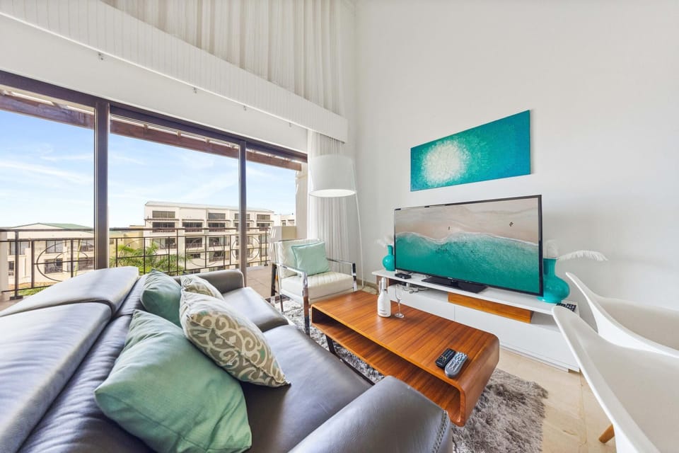 Unwind in this spacious living room with a large cozy couch, big screen TV, and plenty of natural light. Enjoy stunning outdoor views – the perfect spot to relax and recharge.