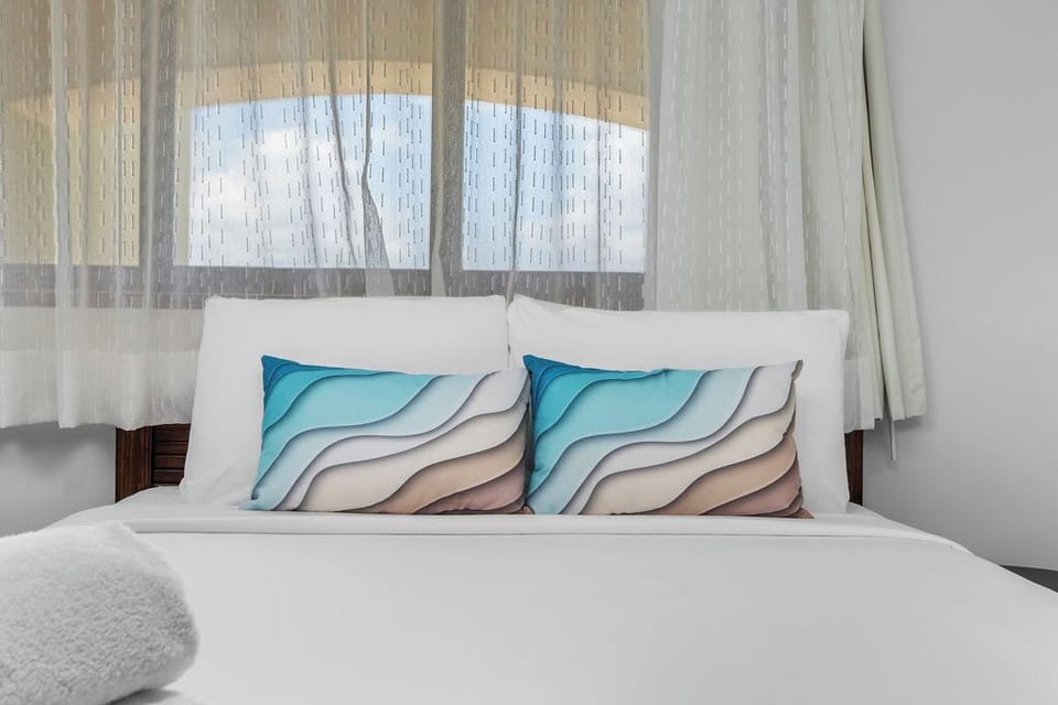 Drift into comfort in a cozy bedroom featuring a plush queen bed — the perfect retreat after a day of exploring.