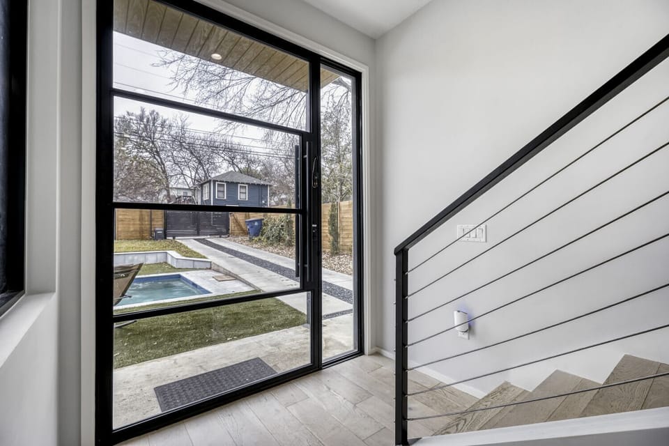 Enter the oversized modern door to the open concept floorplan