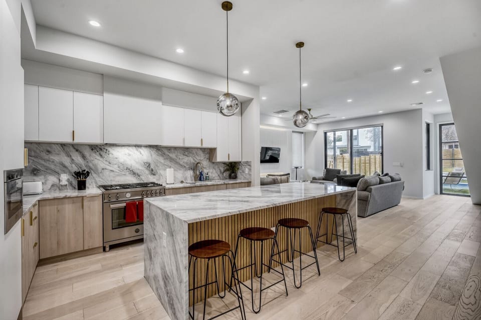Spacious kitchen with a large island and seating, ideal for enjoying morning coffee or group meal prep.