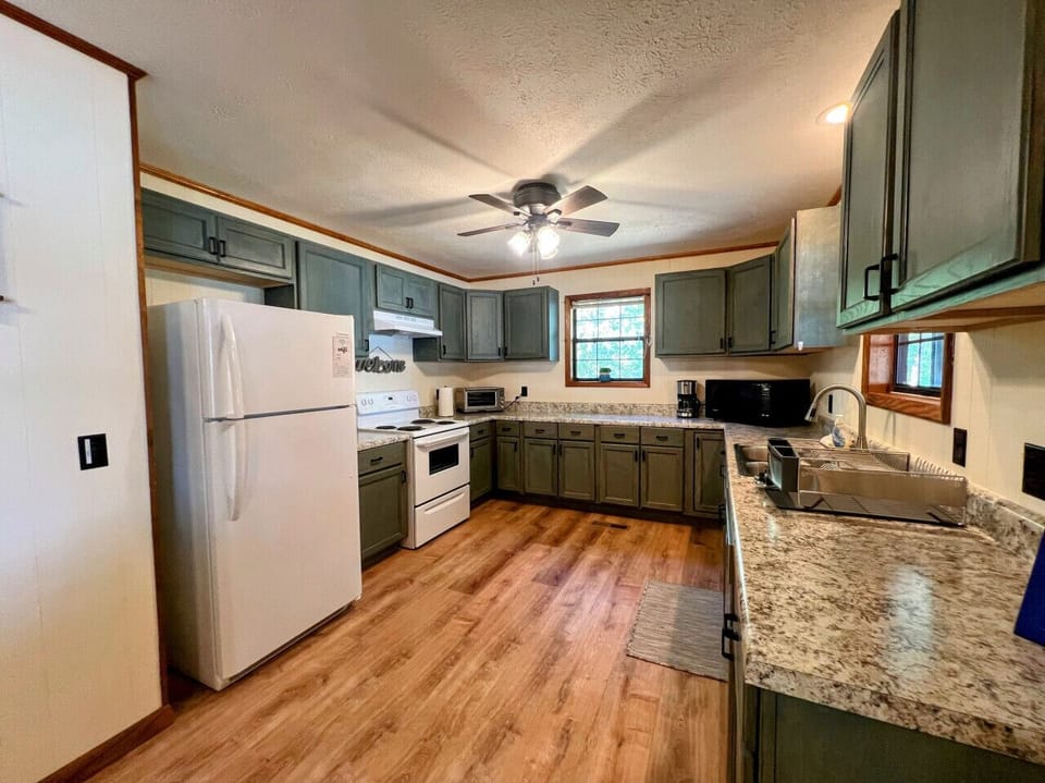 Large open well stocked kitchen with views overlooking Weiss Lake