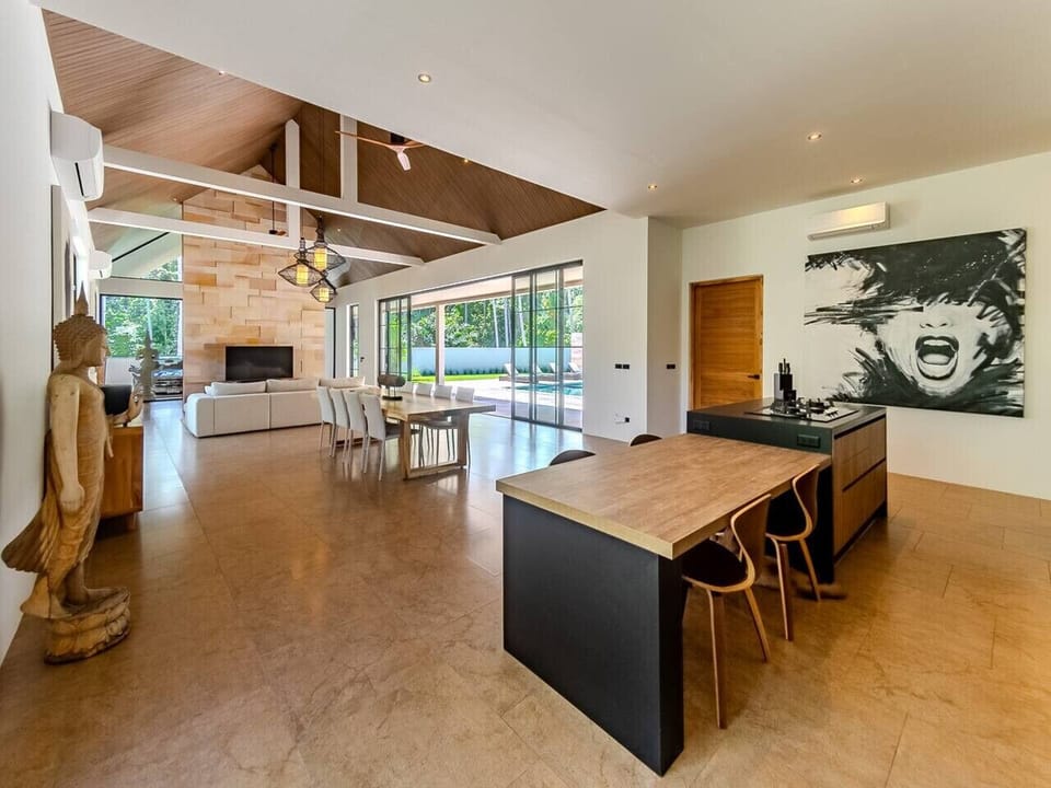 Open-plan living and dining area with soaring ceilings at Koh Samui luxury villa rental