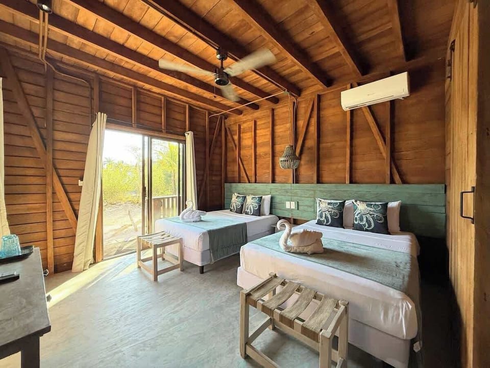 Bedroom with two beds and wood walls