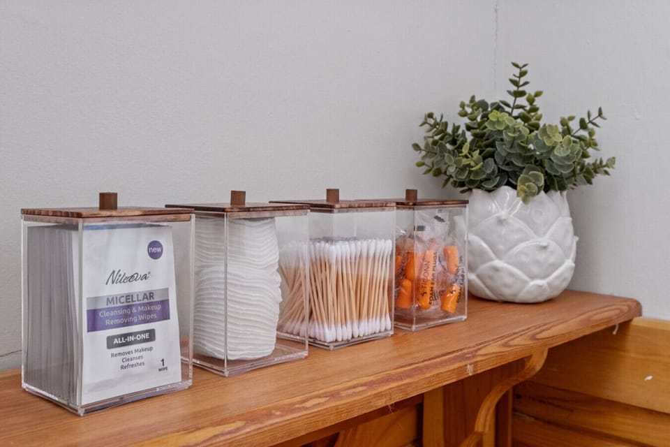 Both bathrooms have makeup remover wipes, cotton rounds, Q-tips, and earplugs