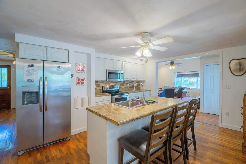 A view of the kitchen.  This kitchen is fully stocked ready for you to make your meals!  This home is in a remote area, be sure to grab some groceries on your way in! Ask your host which grocery store would be most convenient.