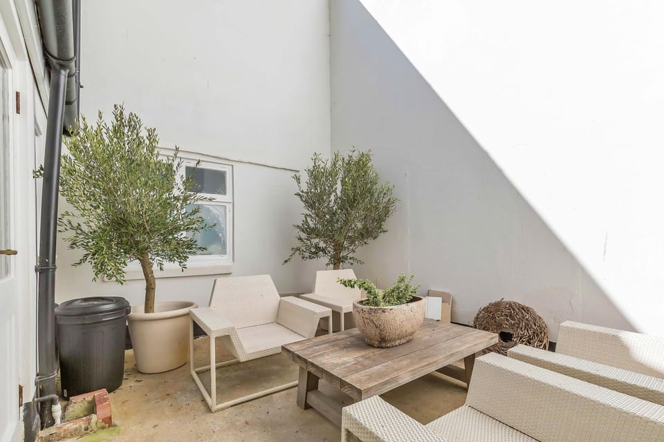 Cosy outdoor space with potted plants and soft lighting, ideal for relaxing