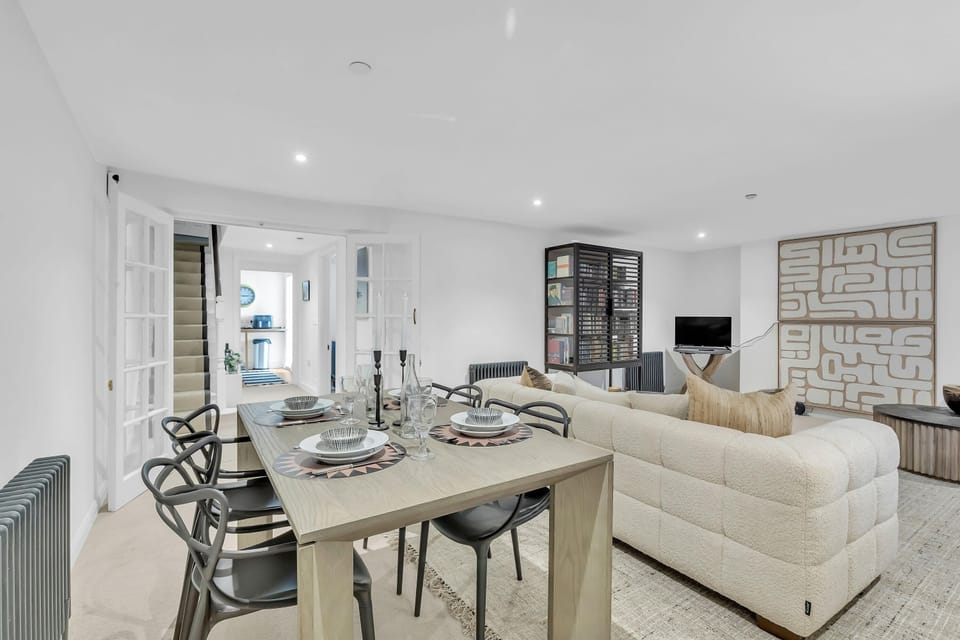 Comfortable open-plan living space with soft furnishings and access to dining area
