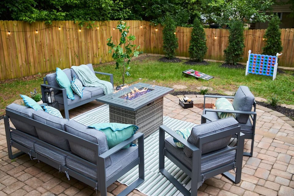 This serene backyard lounge at Lagom Home Raleigh blends modern comfort with forest-lined privacy — perfect for late-night laughs, morning coffee, or a glass of wine at golden hour.