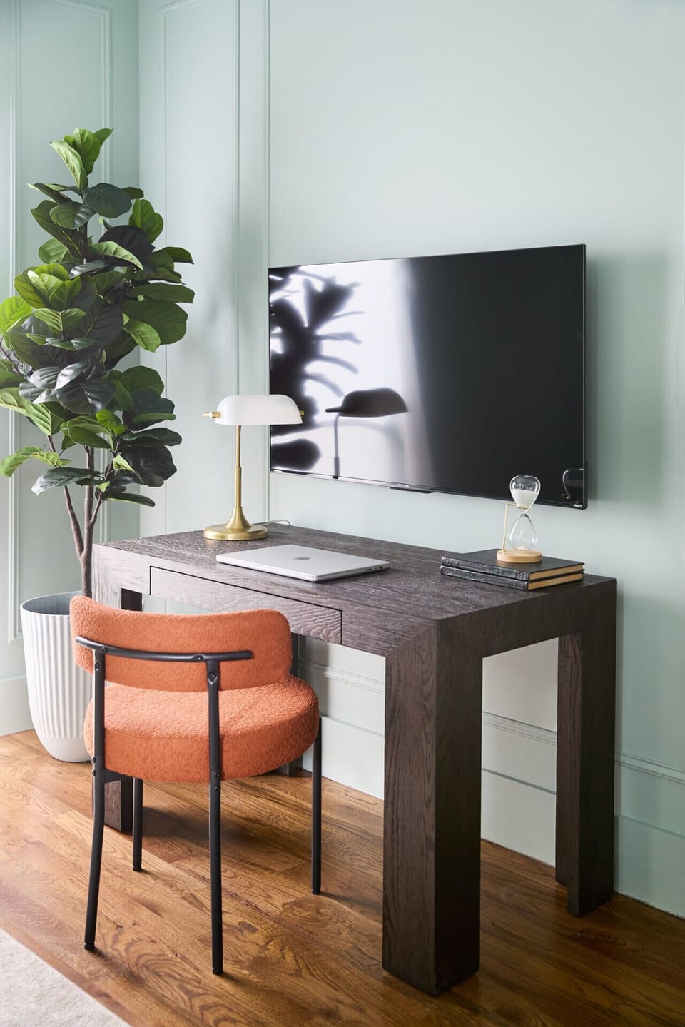 The primary bedroom features a sleek, solid Restoration Hardware desk, perfect for any work you need to do, as well as a 55` TV.