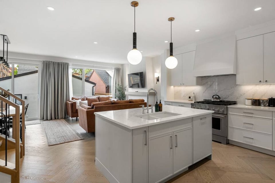 Full kitchen with a large island, coffee makers (drip & french press), and an air fryer.