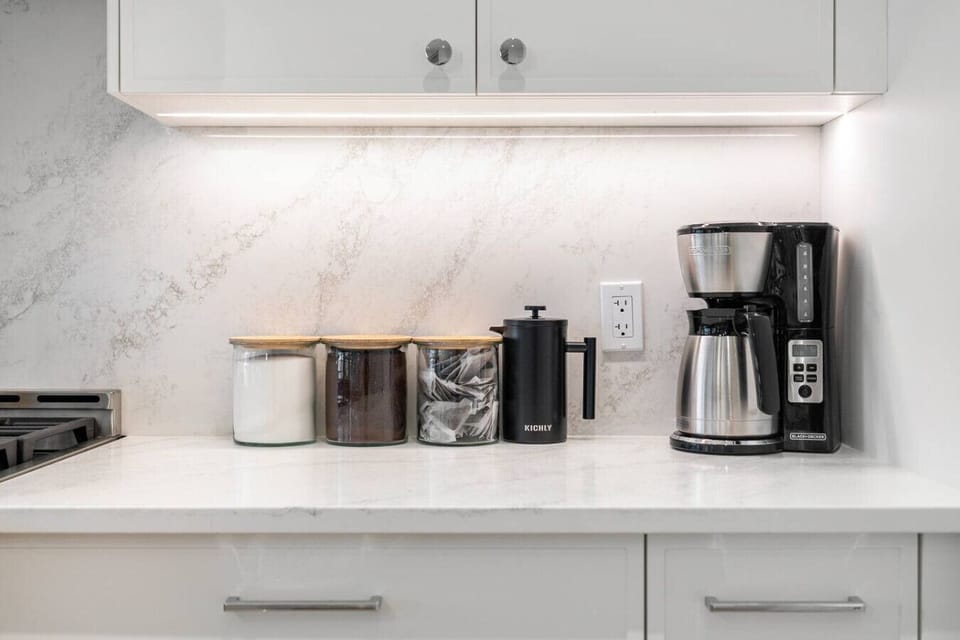 Full kitchen with a large island, coffee makers (drip & french press), and an air fryer.