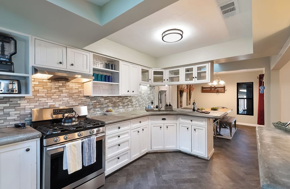 Fully stocked cabinets include an air fryer, toaster oven, and waffle iron.