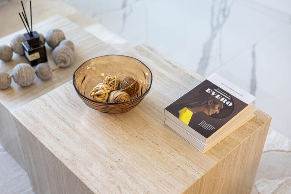 Coffee table with books, decor, and a stylish bowl centerpiece