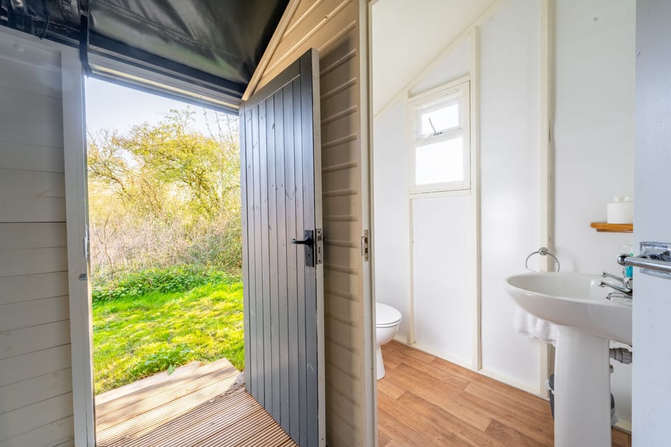 Side entrance to the tent and shower room and separate WC