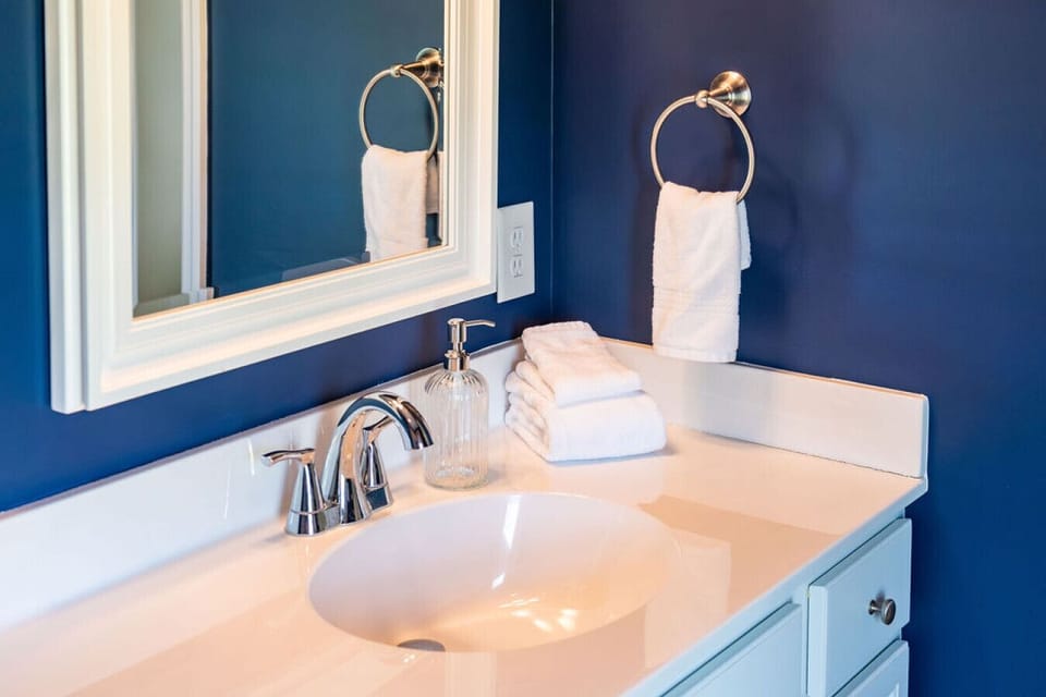 Primary bathroom vanity featuring fresh towels, modern fixtures, and a clean, inviting design