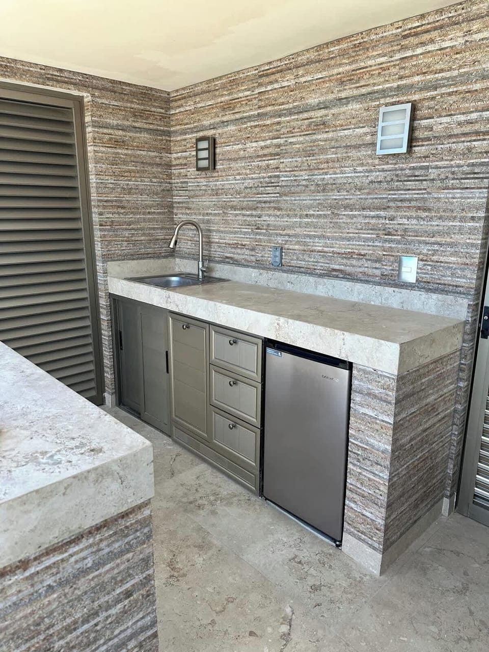 Outdoor kitchen includes, sink, trash bin and small refrigerator for convenience of keeping your drinks cold and easy access so more of your time is spent relaxing in pool and enjoying the gorgeous views. 