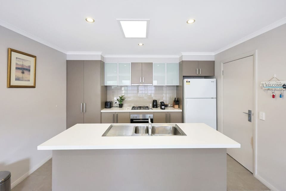 Modern kitchen with island bench and essential appliances