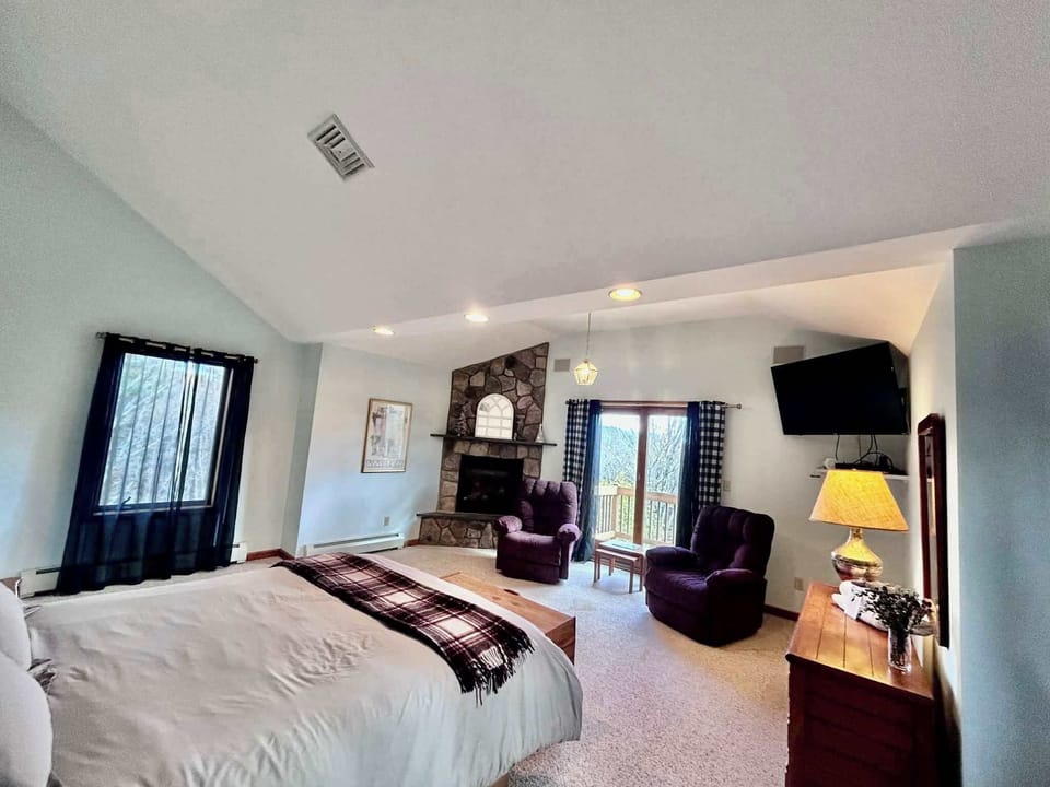 Upstairs Master Bedroom Featuring Crows Nest Balcony, in room Gas Fireplace and Queen Bed.   