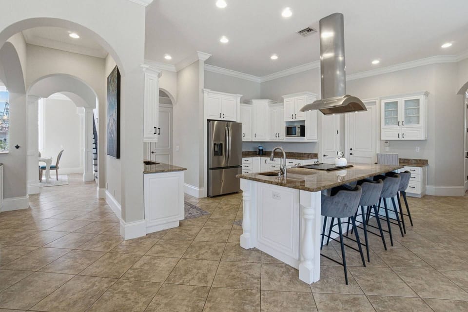 Just past the dining area and bar opens into the spacious, fully-equipped kitchen.