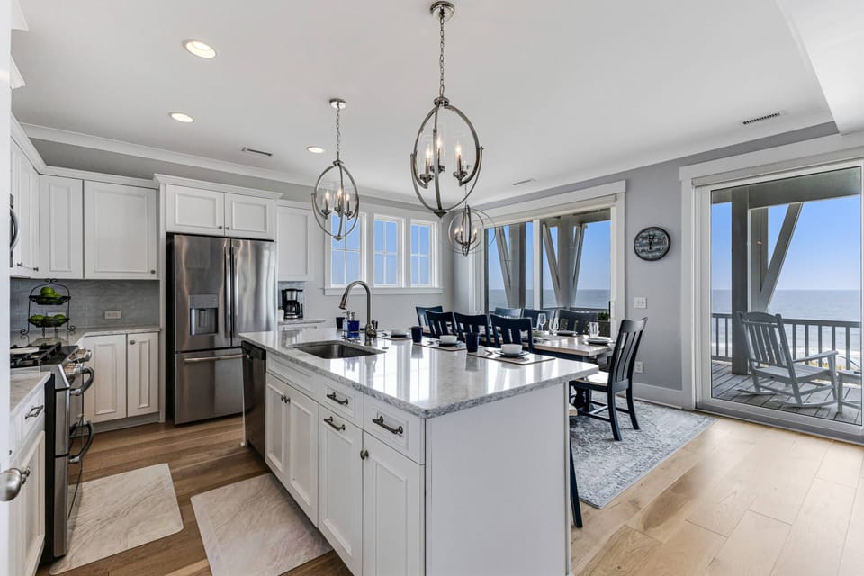 The upper level kitchen/dining room is an open concept plan with the living room. Large windows allow this entire area to be bathed by natural light.