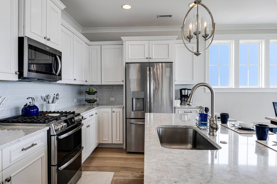 This fully stocked kitchen includes a gas stove & dual ovens. There is lots of room to prep & serve meals.