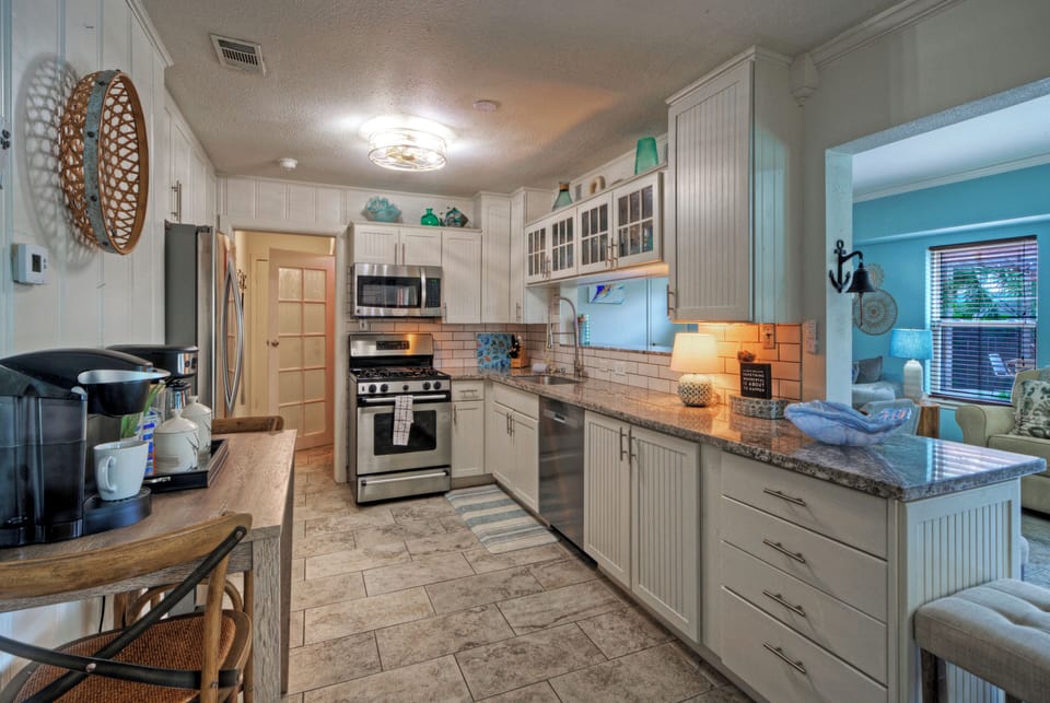 Coastal-inspired kitchen with stainless steel appliances, ample counter space, and everything you need for easy meals at home.